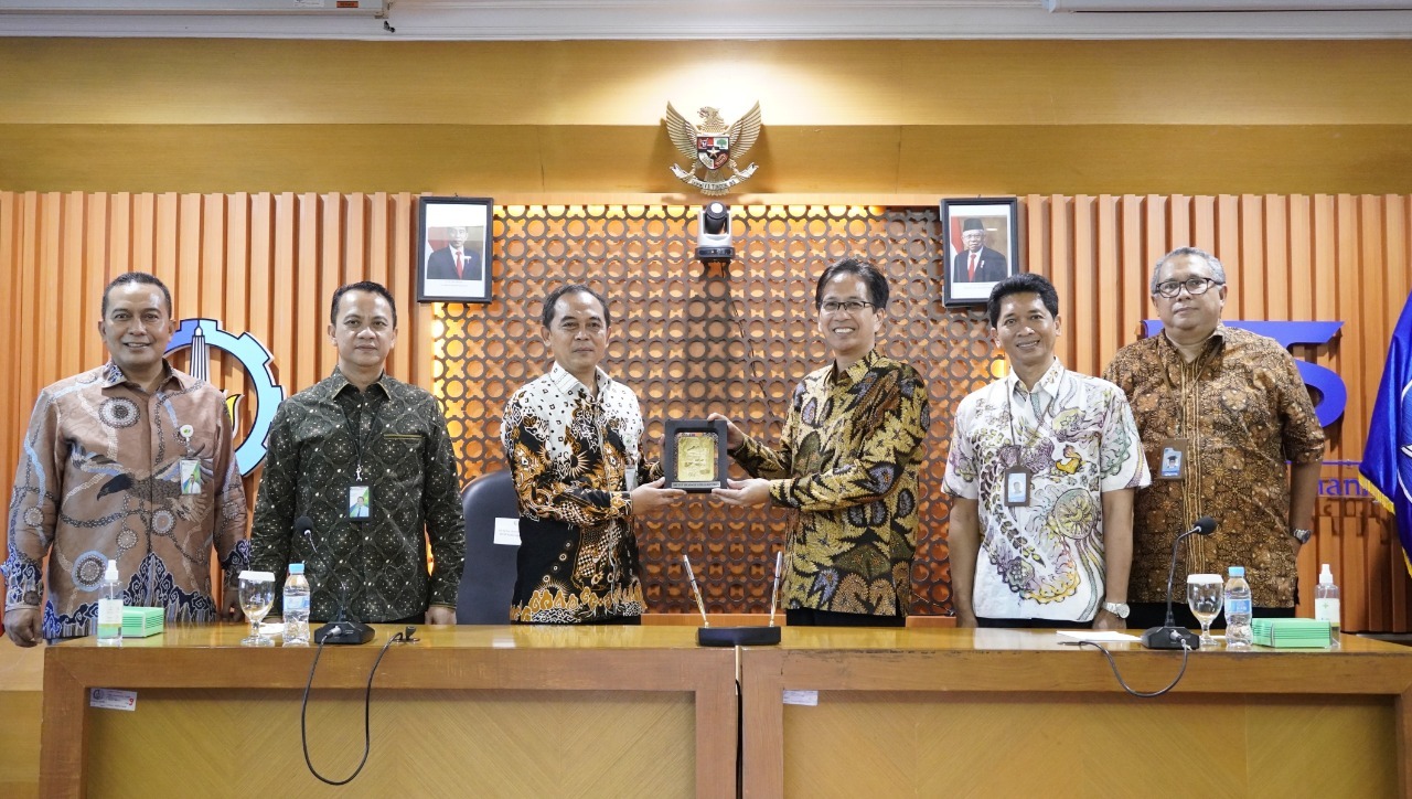 Saling menukar cinderamata antara ITS dan BPJS Ketenagakerjaan usai penandatanganan MoU